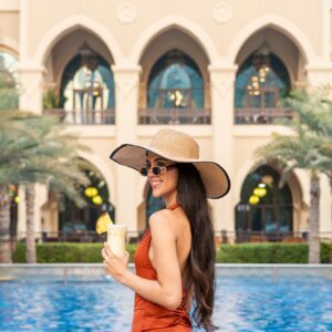 Lady By The Outdoor Swimming Pool At Palace Downtown Dubai Hotel